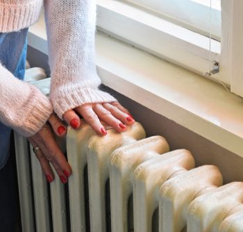 A radiator that is next to a closed window