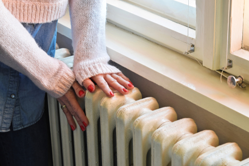 A radiator that is next to a closed window