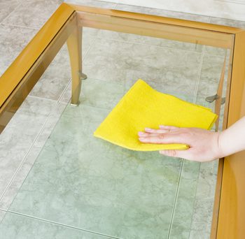 An image of a man cleaning a table